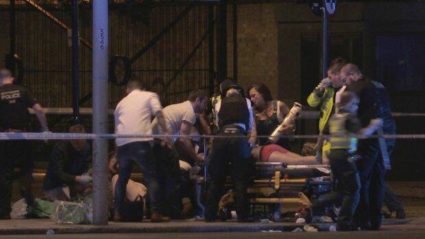 People receive medical attention in Thrale Street near London Bridge following a terrorist incident. Photo: Federica De Caria