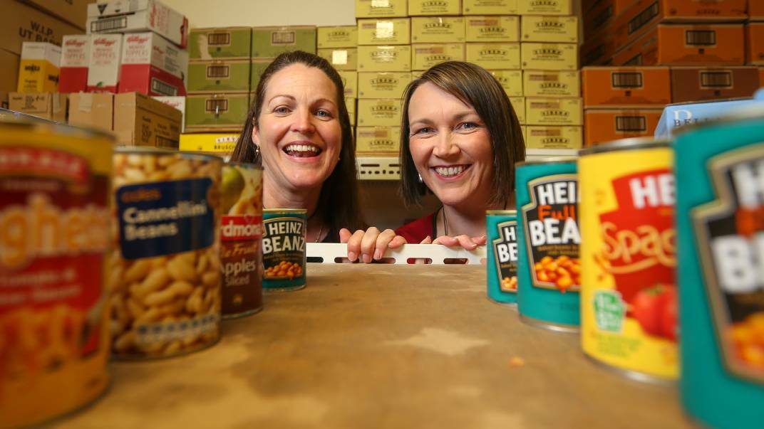 SURE CAN: UnitingCare Wodonga agency manager Naomi Jansen and Border woman Ainsley Stone hope Border businesses will embrace One Can Can in the nine-week countdown to Christmas. Picture: JAMES WILTSHIRE