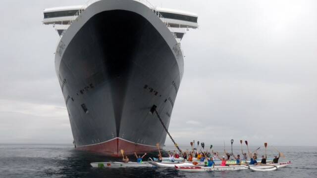 The Geographe Outriggers paddled out to the depths of Geographe Bay to welcome the Queen Mary 2 on its first voyage into Busselton. Photo supplied.