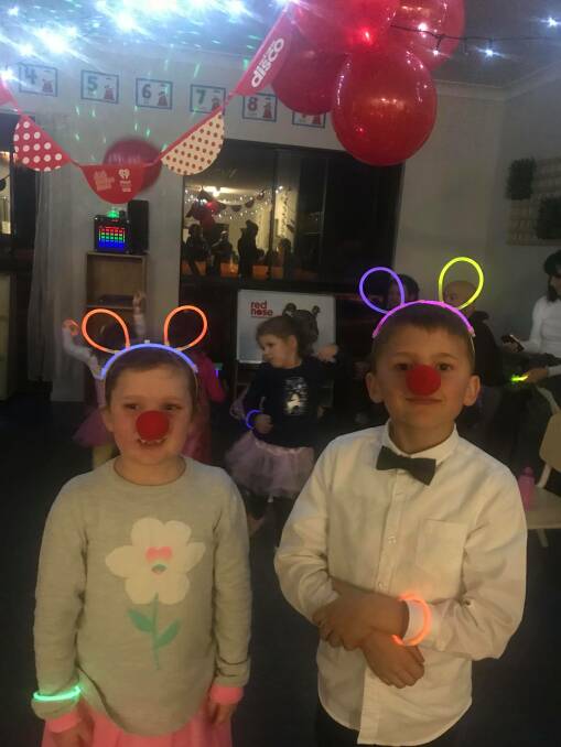 Isla and Euan Hayward with their glow gear at the Red Nose disco. Image supplied.