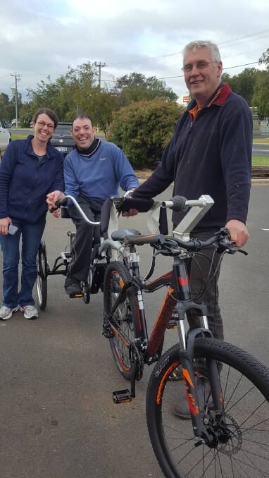 South West Machinery owner Phil Ashton, Jonnie and Sue with their modified bicycle. Image supplied.