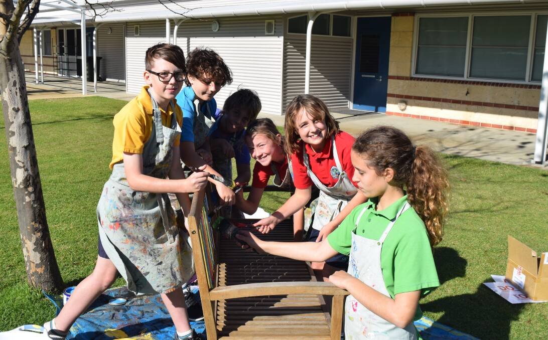 Georgiana Molloy Anglican School year six students Samuel Locock, Darcy Keough, Noah Gilmour, Alannah Yuen, Erin Lea Forrest and India Zoric painting their buddy bench.