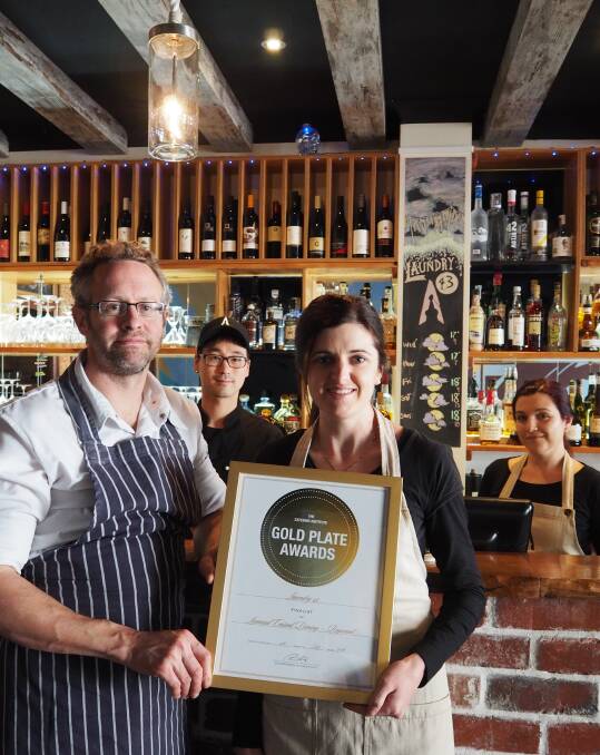 Head chef Nathan Thomas holding the Gold Plate Finalist Award with Karis Silke. Behind the bar is Chef Chori Kim and sommelier Micaela Zanda. Photo by Lily Yeang.