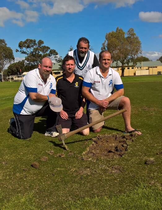 St Marys cricketers Anthony Balkin, Karl Clively, Wayne Thackrah (rear) and Ben Crain preparing to get their souvenir pieces of the Churchill Park cricket wicket.