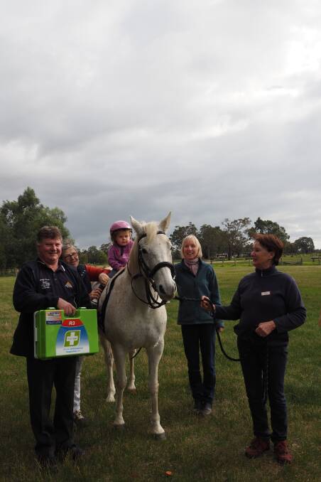 Apex's Peter Rann holding the First Aid kit the volunteer organisation donated to RDA, along with hippotherapy team Lorraine Pearson, Denise Phillips and Marie Wendland with  Sage Veurink on Lucy the horse. Photo by Lily Yeang. 