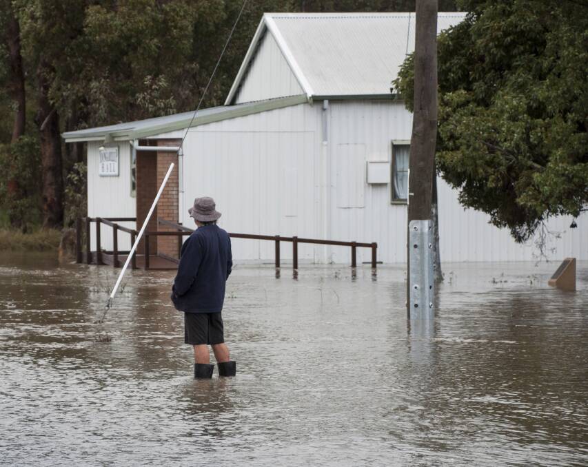 A Yoongarillup resident watches as the water level rises near the Vasse Highway in the South West on Friday. Photo by Wendy Slee. 