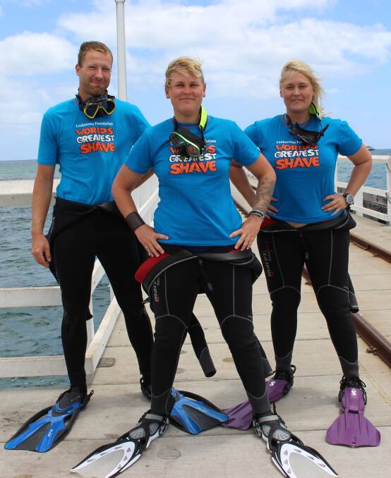 Diver Megan Macdonald (pictured centre) has dared to go bald under the crystal blue water of the Geographe Bay to raise funds for the Leukemia Foundation. Pictured here with Alecia Macdonald and Konrad Herzig. Photo: Ivy James 