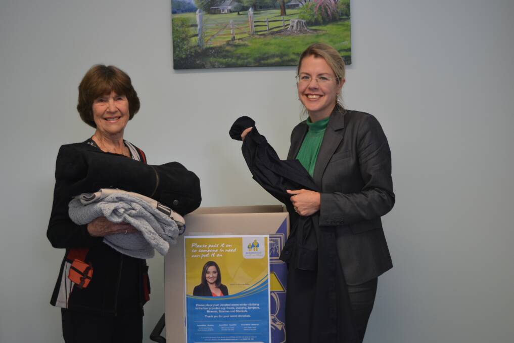 Flo Rose and Libby Mettam donating coats for the appeal