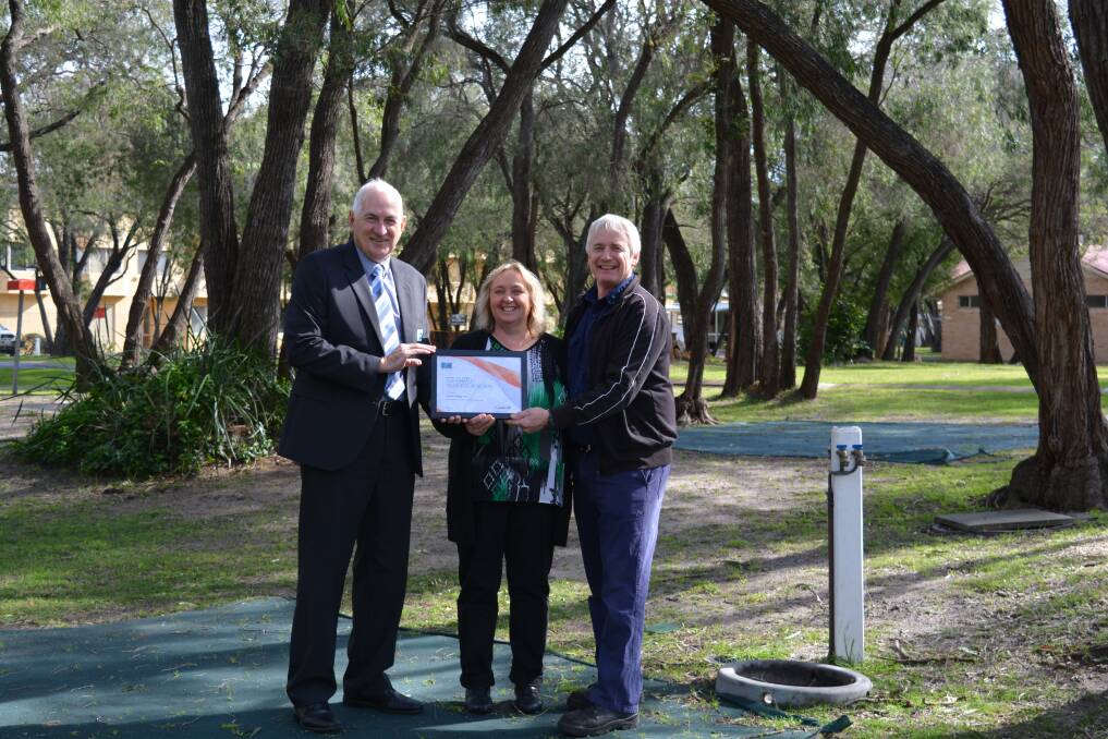 Busselton Water CEO Chris Elliott presenting the Waterwise Business in Action certificate to Amblin Holiday Park Managers Ross and Helen Duits. 