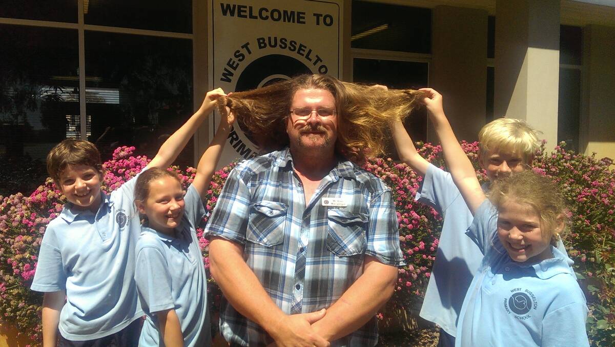 West Busselton students James, Haylee, Tayte and Katelyn checking out deputy principal's Alan Macgregor's hair for the first time as he grows it for charity. Photo by Alison Downard.