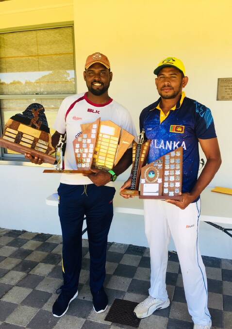 TROPHY HAUL: Sri Lankan cricketers Kavy de Silva and Buddhika Sanjeewa received their haul of last season’s Association trophies before Saturday’s game for Cowaramup against Dunsborough. Photo: Supplied.