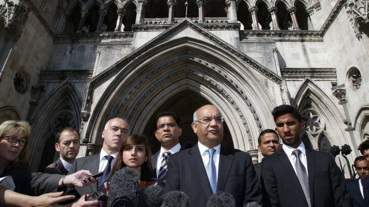 Labour MP Keith Vaz, centre, talks to the media as late nurse Jacintha Saldanha's family, including her husband Benedict Barboza, 5th left, her daughter Lisha, 4th left, and her son Junal, right, listen following an inquest into her death. Photo: Lefteris Pitarakis
