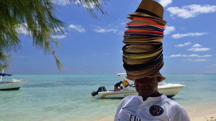 Souvenir hats: An abundance of choice from this seller in Mauritius.
 Photo: Alamy 