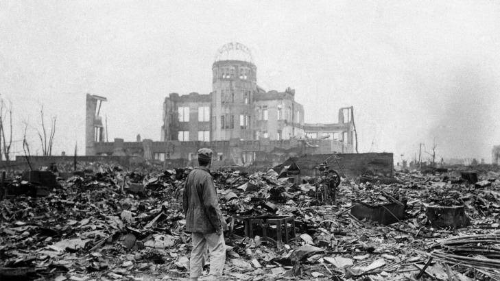 An allied correspondent stands in the rubble of Hiroshima, Japan, a month after the first atomic bomb ever used in warfare was dropped by the US.  Photo: AP/File