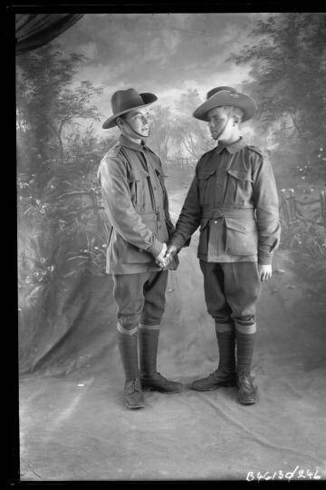 Handing over: Soldiers and friends George Bickerstaff and Joseph McQueen pose for a pre-embarkation photograph. Photo: State Library of South Australia B 46130/241