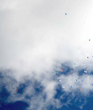 Red, white and blue baloons released at the funeral of Regan Burton. Photo: Andrew Elstermann