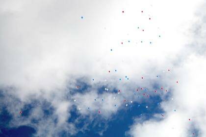 Red, white and blue baloons released at the funeral of Regan Burton. Photo: Andrew Elstermann