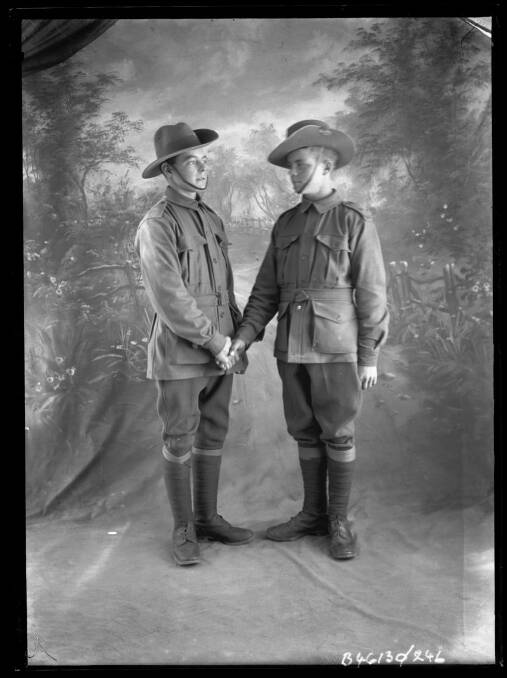 Handing over: Soldiers and friends George Bickerstaff and Joseph McQueen pose for a pre-embarkation photograph. Photo: State Library of South Australia B 46130/241