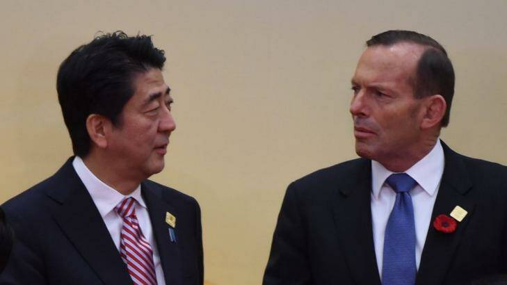 Defence purchases discussed: Prime Minister Tony Abbott chats with Japanese Prime Minister Shinzo Abe at the East Asia Summit in Myanmar.