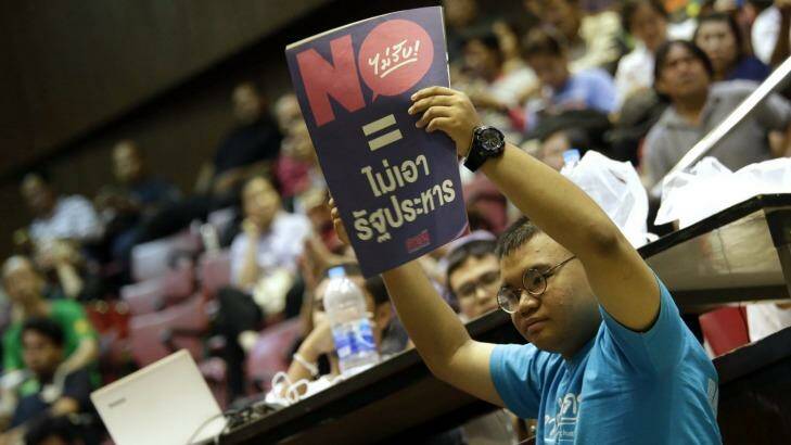A student holds a poster reading "vote no = no coup " at Thammasat University in Bangkok on Sunday. Photo: Sakchai Lalit/AP