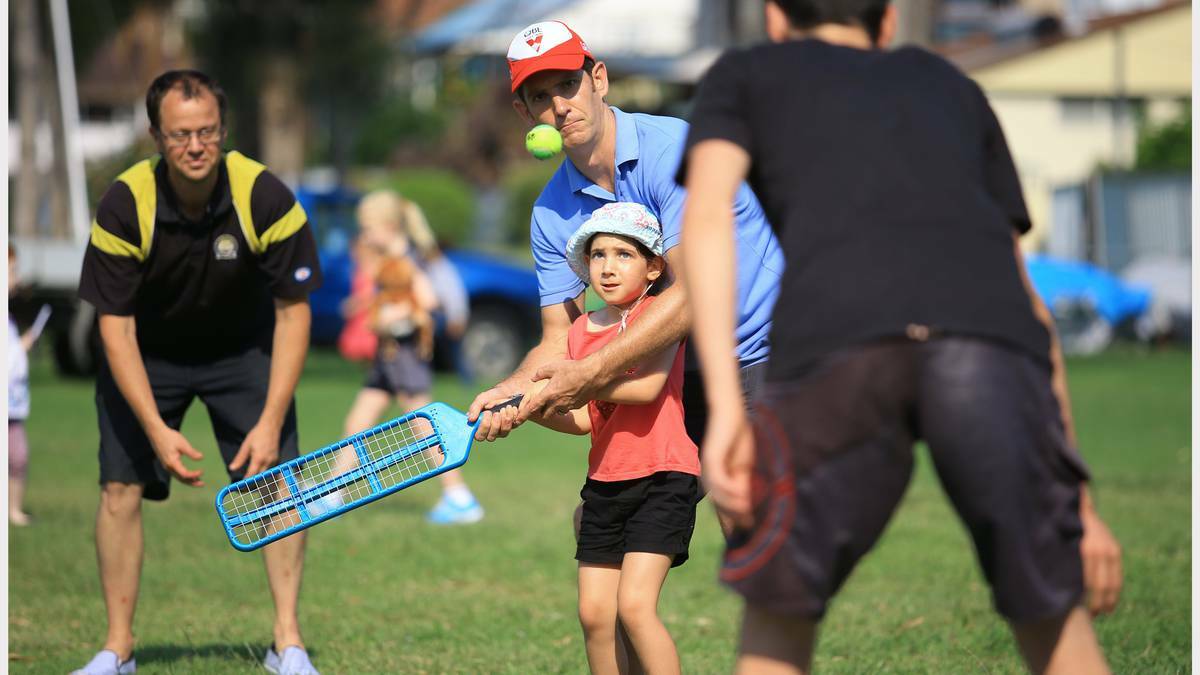 NEWCASTLE: New Years Eve Celebrations at Wangi Wangi - shows Mahalia Pascoe [5yrs] and her dad James Pascoe of Brightwaters playing cricket. Photo: PETER STOOP