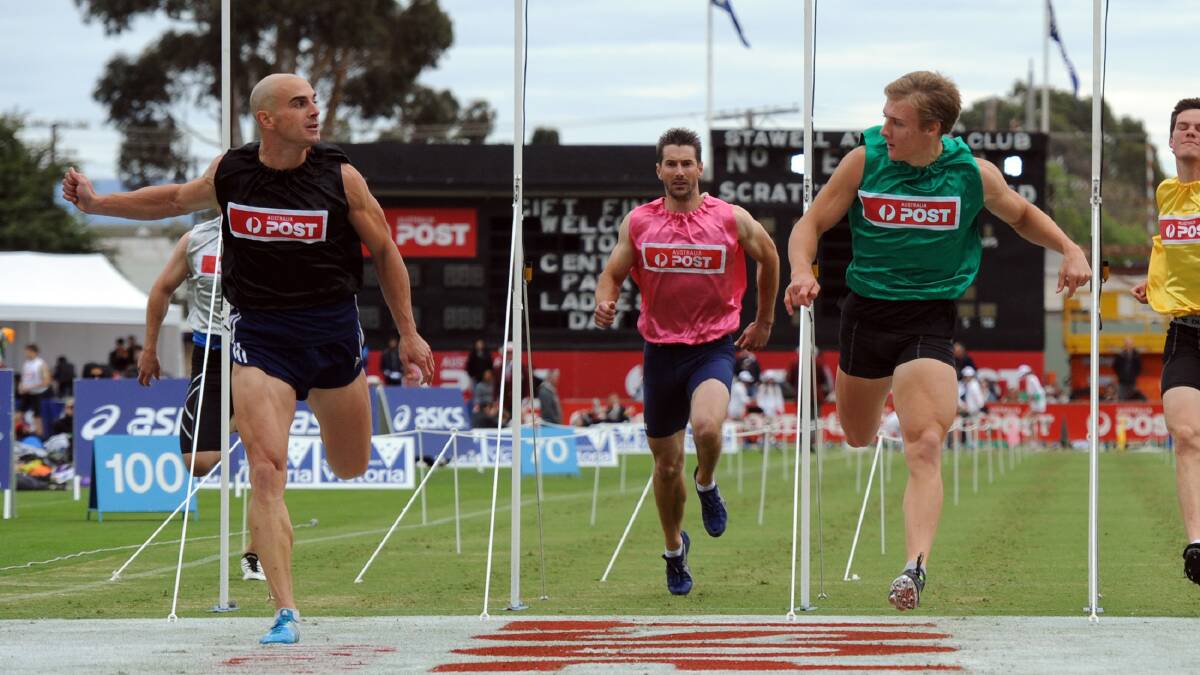 Isaac Dunmall, green, wins heat 20 of the 2014 Stawell Gift. Luke Versace, black, was a close second. 