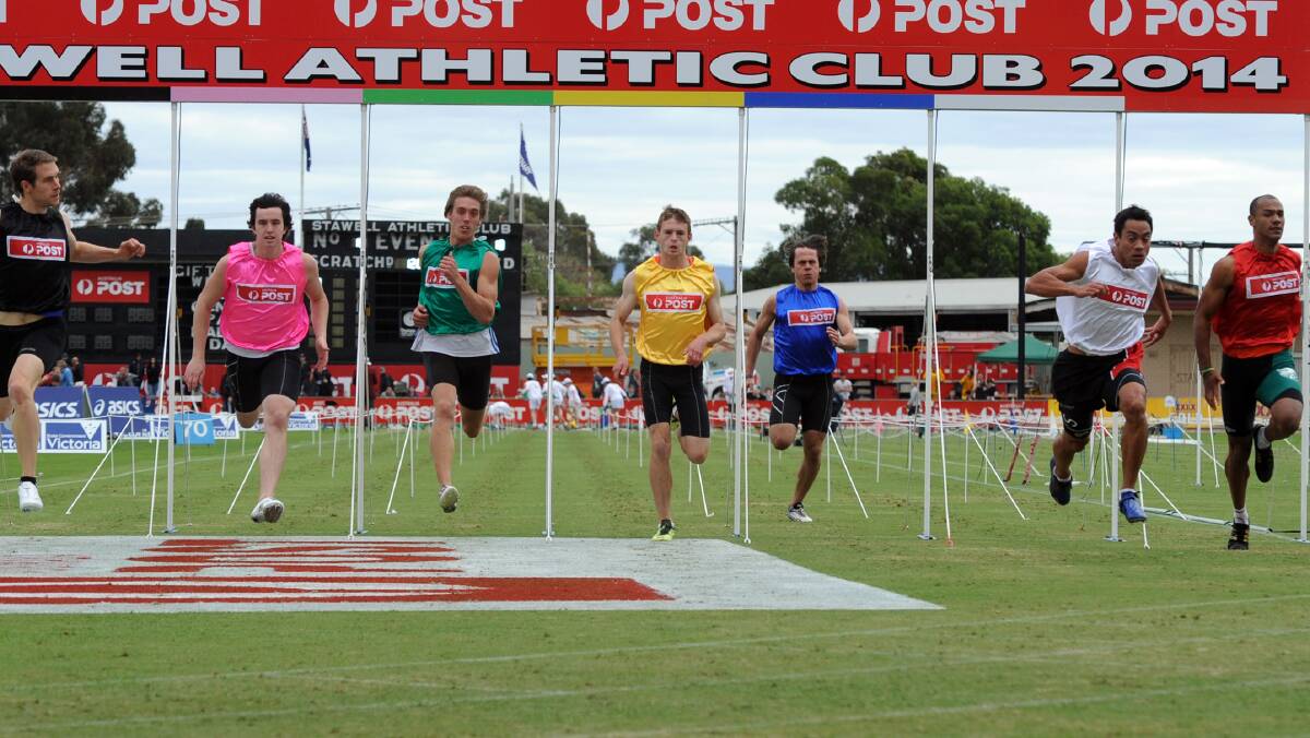 Dean Scarff, white, wins heat 18 of the 2014 Stawell Gift. 