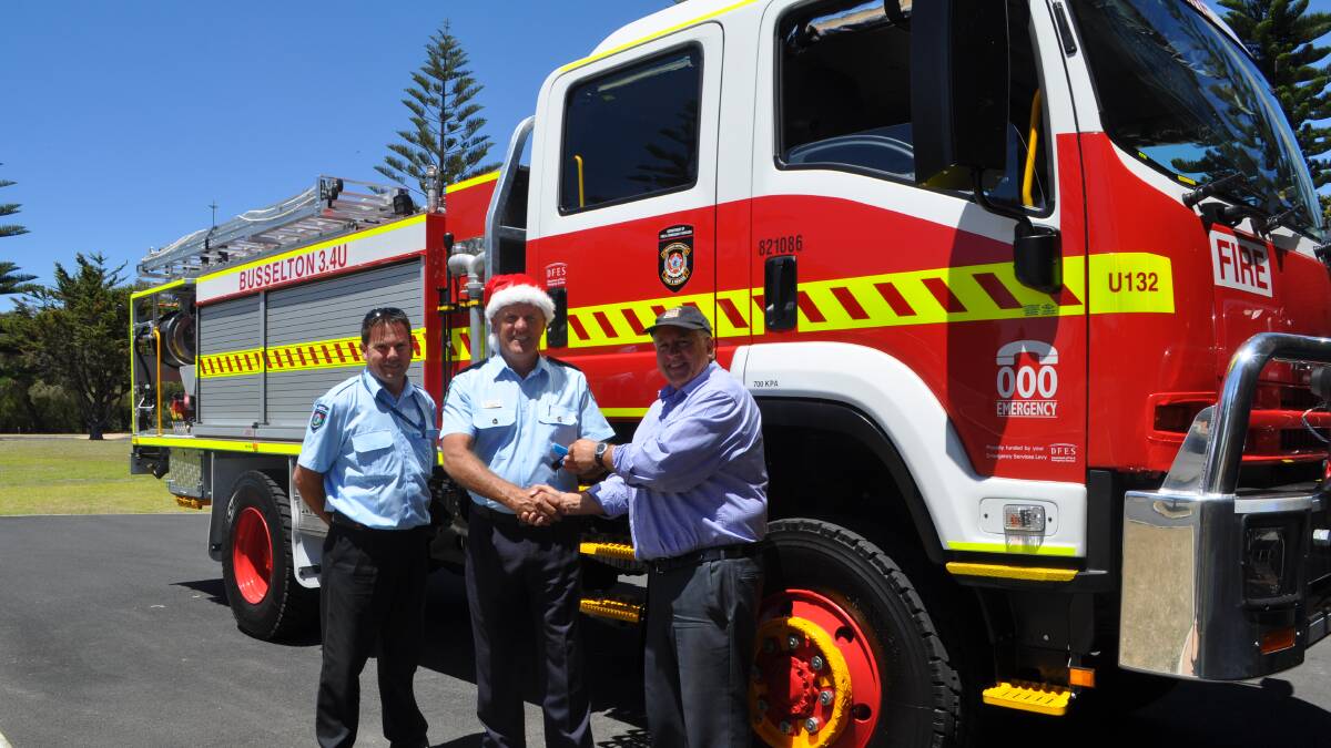 Early present:Fleet engineering officer Steve Herbert and DFES area officer Andy Thompson gift volunteer firefighting captain Robert Papalia with the new truck. 