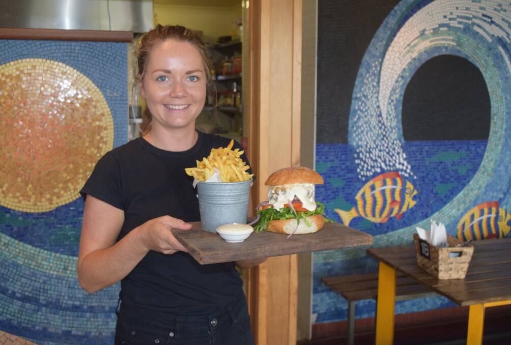 Occy's Food and Brews team member Kaylee Drabble with the chilli beef burger.
