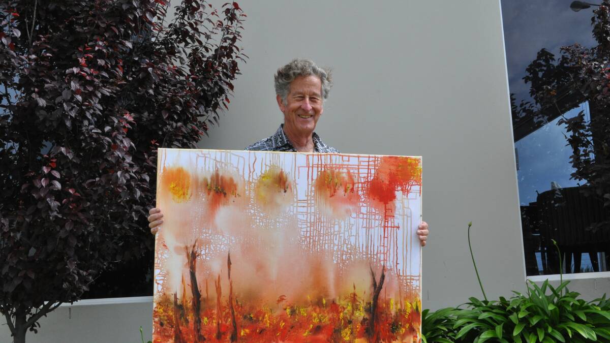 Frank Elliott is holding his sister's painting which will be auctioned off on Friday night.