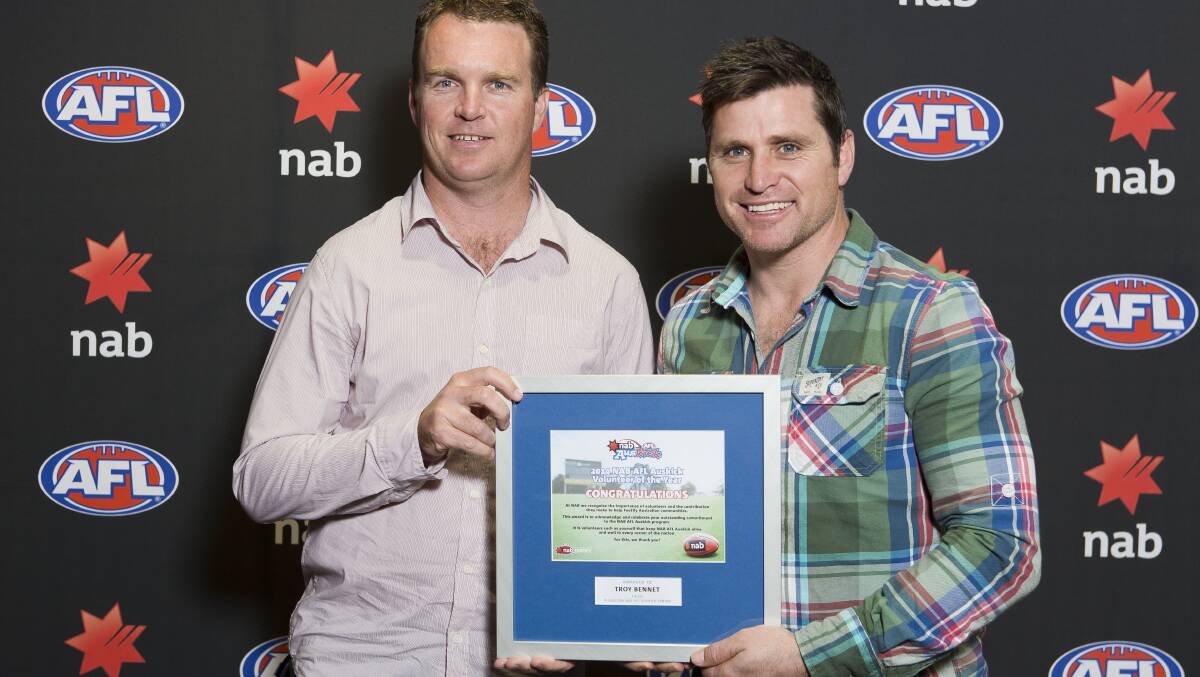 Busselton's Troy Bennet accepting his award from AFL legend Shane Crawford.