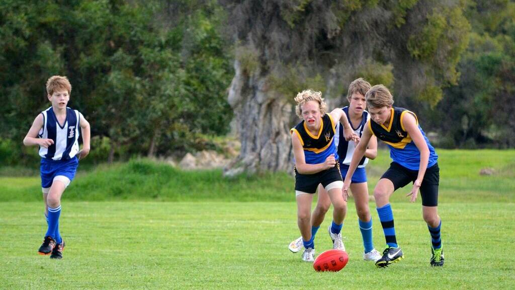 Junior player of the week Liam Argyle has eyes on the ball, with help from Vasse Royal team mate Ky Spowart
