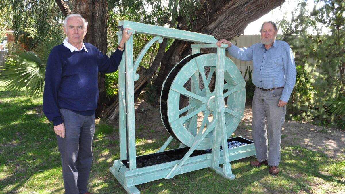 Ross Stanbury and Jim Lofthouse testing the water wheel at the Uniting Church.
