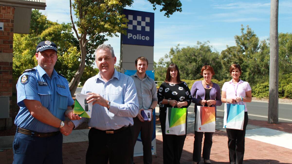 Phone donation: Senior Constable Anthony Smith, Telstra area general manager Boyd Brown, Telstra business manager Brent Tyrrell, Department of Child Protection team leader Wendy Binns, South West Counselling’s Bev Atkinson and Busselton Women’s Refuge care support worker Summa Tarbotton. 