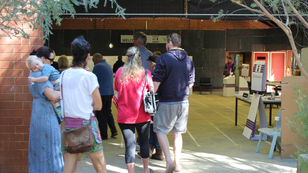 Voters patiently waiting in line at Vasse Primary. 