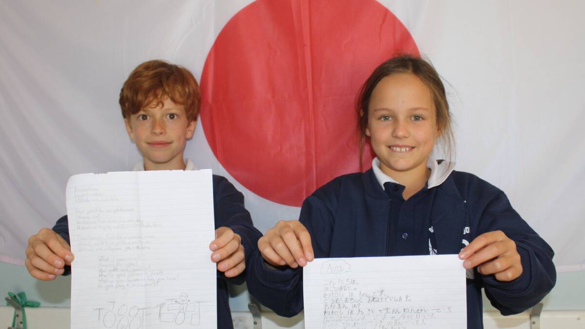 Pen pals: Dunsborough Primary School year four students Josh Beaton and Ava Sproule hold their Hiragana pen pal letters.