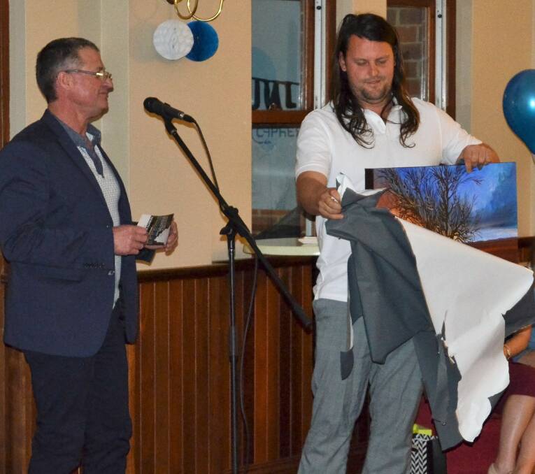 Artistic: Club president Mark Gelmi presents Chris Blackburn with his award for Club Man of the Year. 