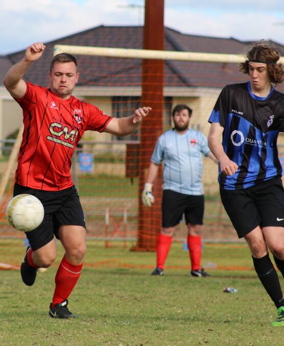 City of Busselton Football Club defender Ian Feakes works hard to keep the ball off Eaton Dardanup attacker in Sunday's three nil win, the last game of the season.