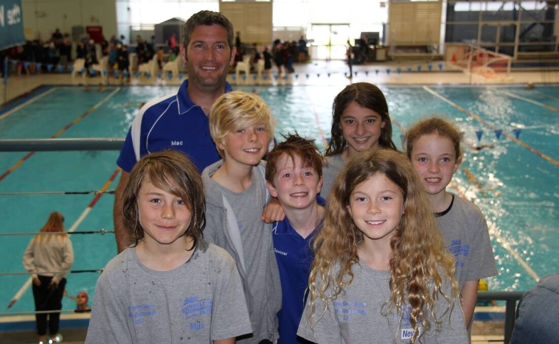 Busselton Swimming Club coach Mac with his team of six junior champs at the WA short course championship.