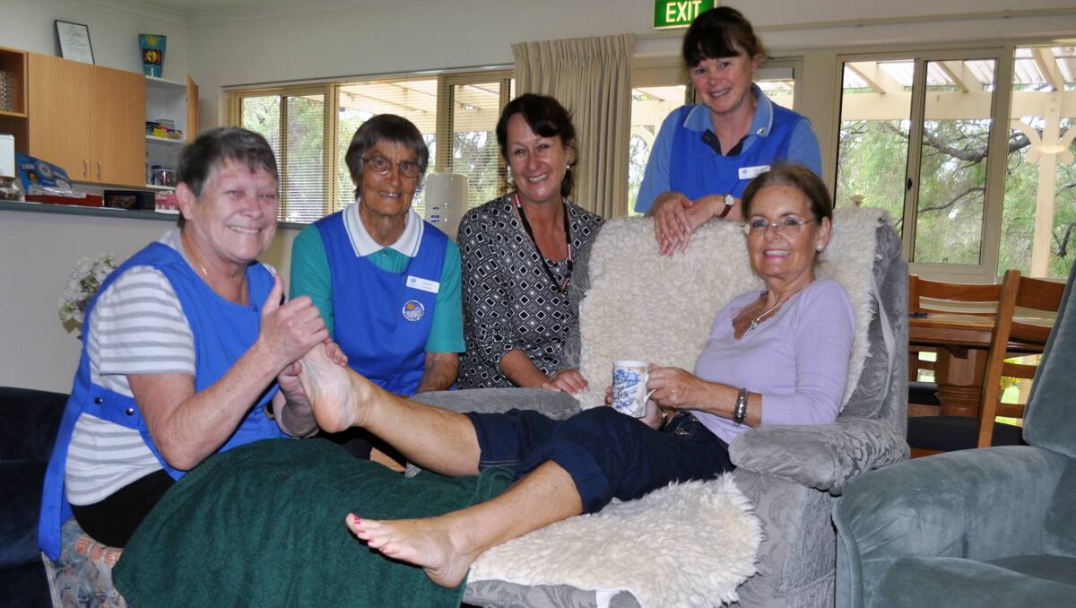 Hospice volunteer Pat Farquharson practices a foot massage on fellow volunteer Frances Lismore while Joan Reid, Liz Bickley and Julie Buegge watch on.