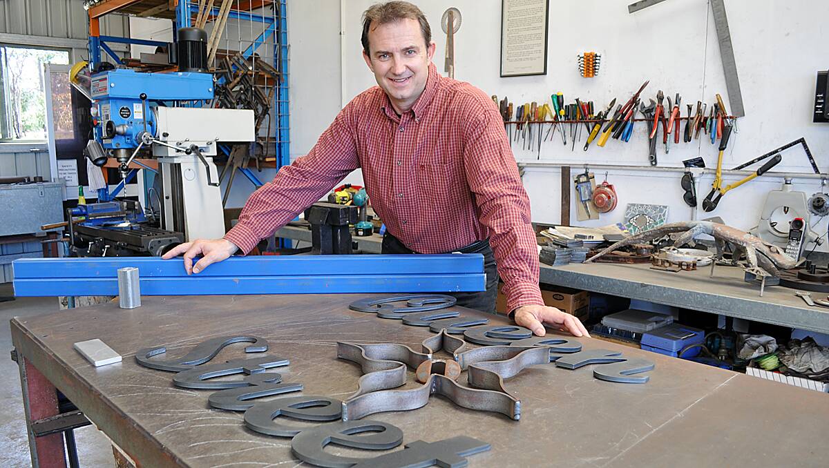 Voytek Kozlowski with the steel lettering that will become the artwork at the entrance to Queen Street.