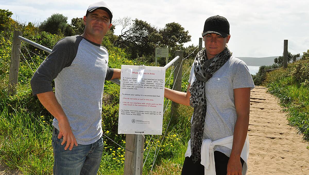 Pro-surfer Jake Paterson and Yallingup Surf School owner Crystal Simpson with the Smiths Beach sign.