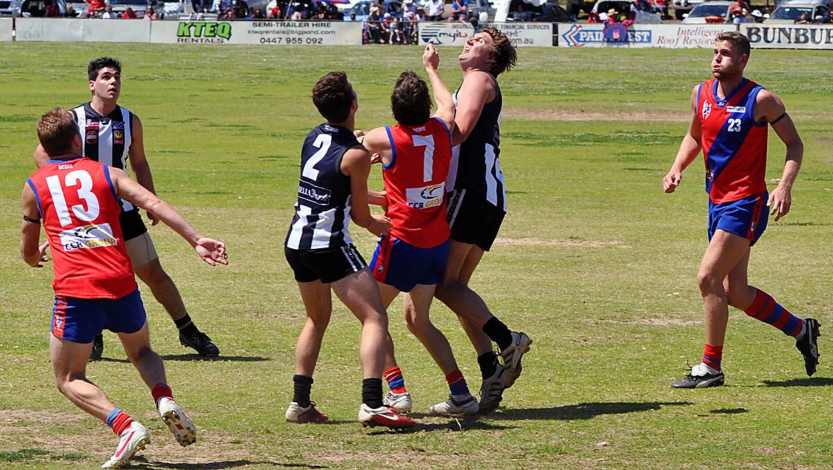 Busselton ruckman Tom Sibson tries to give the Magpies midfielders first use of the football.