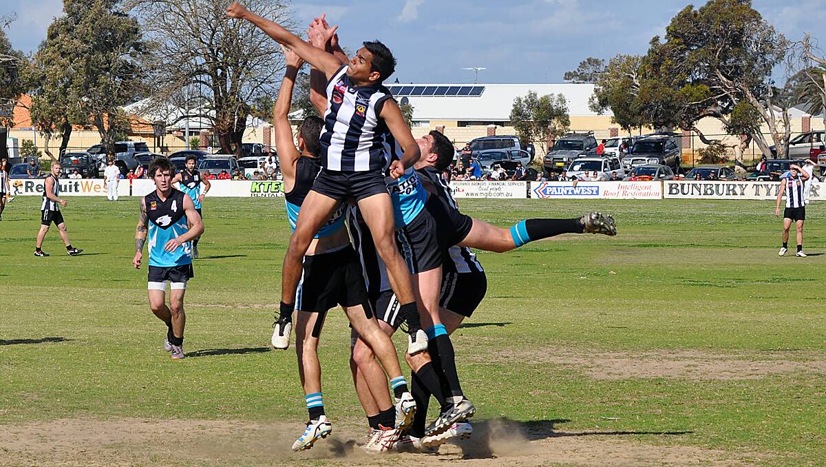 Magpie Brandon Jetta gets a powerful fist to prevent Collie from taking a mark.