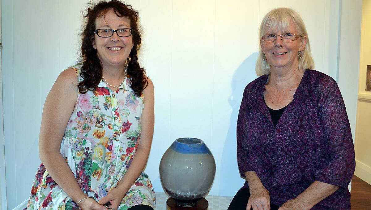 Margot Edwards and Sally Hays with the Bushfire Vase created by Gerry Reilly, representing a pyro-cumulus cloud.