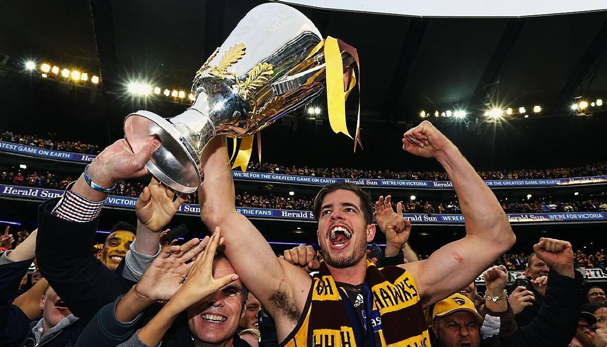 Ben Stratton celebrates with fans after lifting the AFL premiership cup. Photo: Getty Images