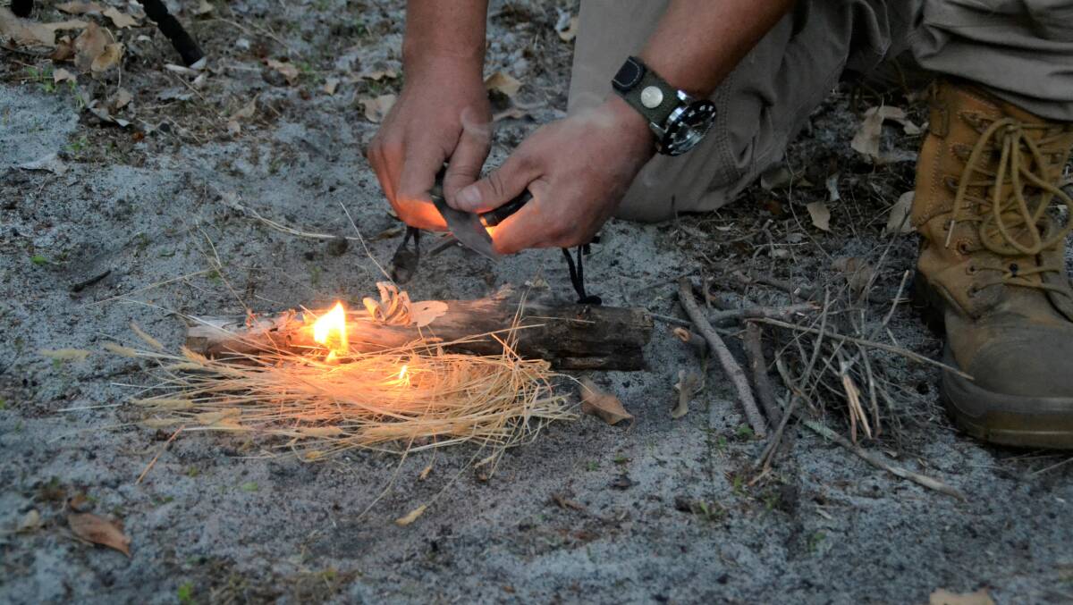 After cutting a piece of wood using a technique called 'feathering', Mr Widmer uses a knife and a feroccium fod to light a fire. 
