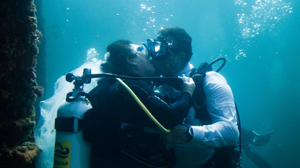 Taking the plunge: Cameron and Debby McLeod celebrate their nuptials in the waters off Busselton Jetty. Photo: Fox and Luna Photography