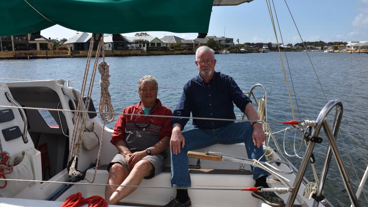 Geographe Bay Yacht Club commodore Barry McLennan and social sailing organiser Gavin Sorrell are stuck inside the marina walls as wrack buildup prevents keel boats from exiting or entering Port Geographe.