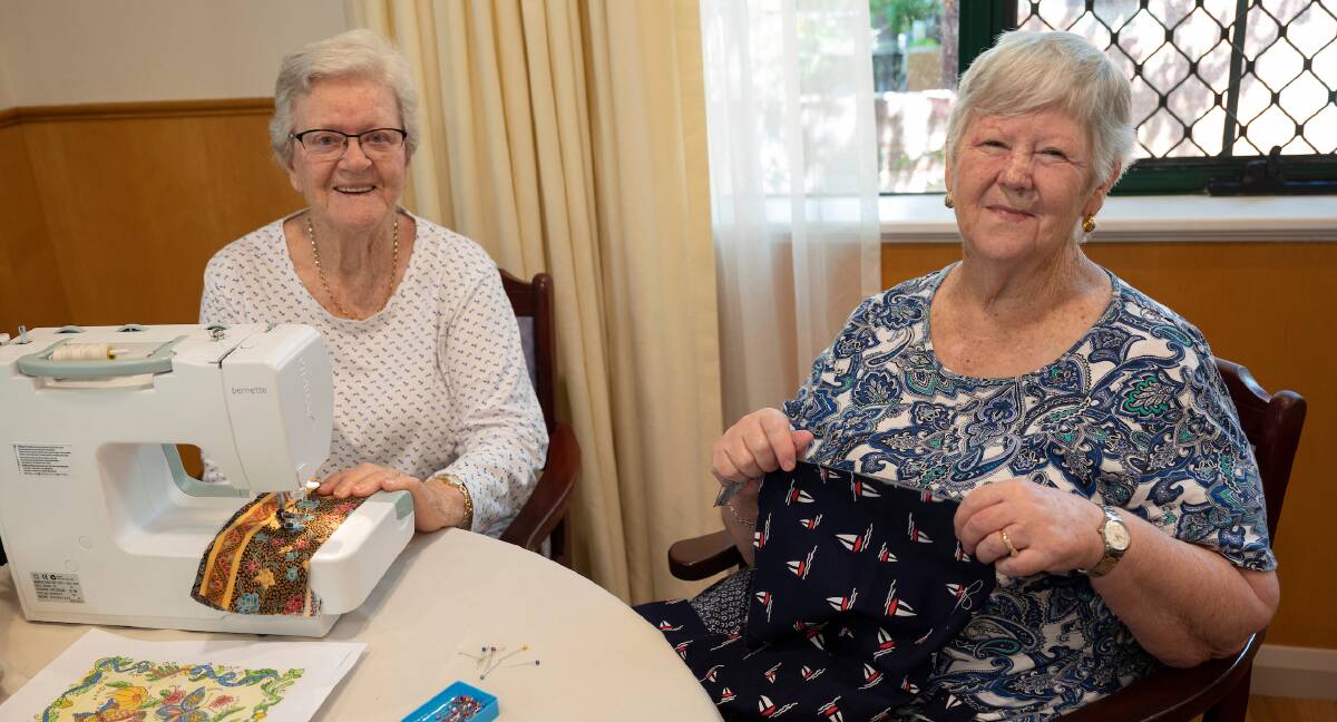 Back into it: Sewing group members Bev Perrott and Edna Langridge enjoy the new memories their social circle creates. Picture: Supplied.
